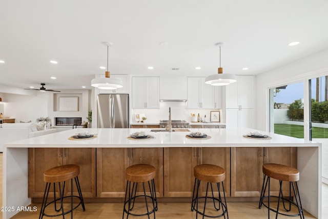 8403 E Fairmount Ave, Scottsdale, AZ 85251 - kitchen with freestanding refrigerator, light countertops, white cabinets, and recessed lighting