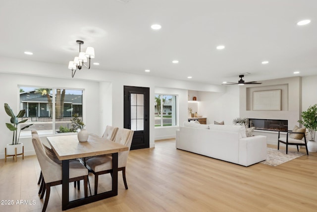 8403 E Fairmount Ave, Scottsdale, AZ 85251 - dining room with light wood-style floors, recessed lighting, a glass covered fireplace, ceiling fan, and baseboards