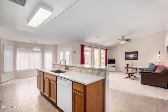 kitchen featuring visible vents, dishwasher, lofted ceiling, open floor plan, and a sink