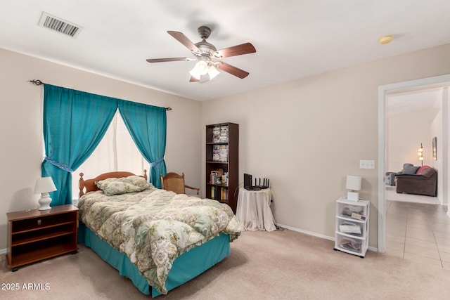 tiled bedroom with a ceiling fan, baseboards, visible vents, and carpet flooring