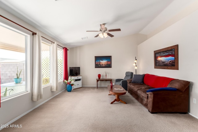 carpeted living area with lofted ceiling, ceiling fan, and baseboards