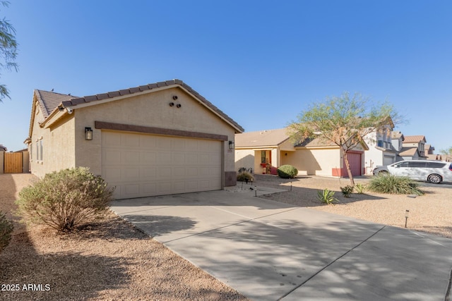 view of front facade with a tile roof, stucco siding, concrete driveway, a garage, and a residential view