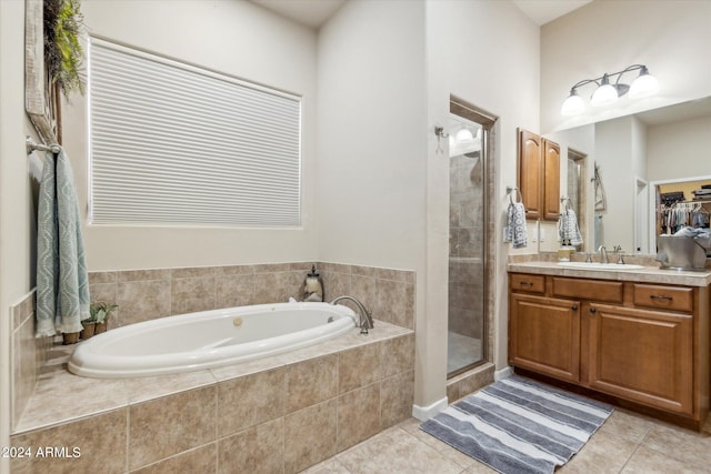 bathroom featuring vanity, plus walk in shower, and tile patterned floors