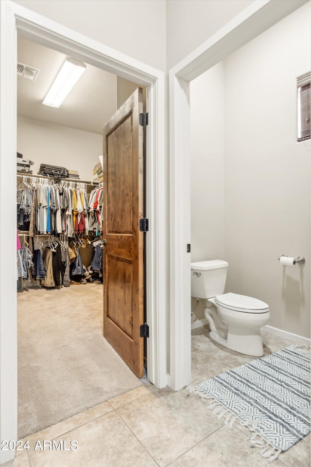 bathroom with tile patterned flooring and toilet