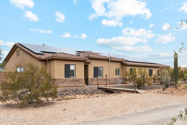 view of front facade with solar panels