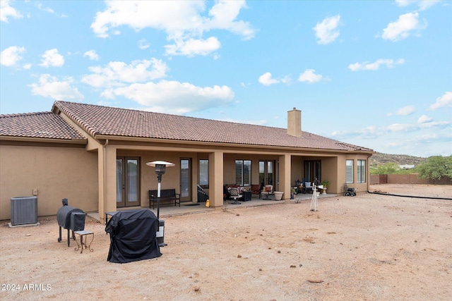 rear view of property with a patio and central AC