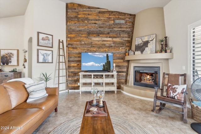 living room featuring light tile patterned floors, high vaulted ceiling, and a fireplace