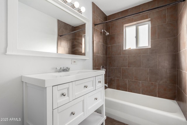 bathroom with tiled shower / bath combo and vanity