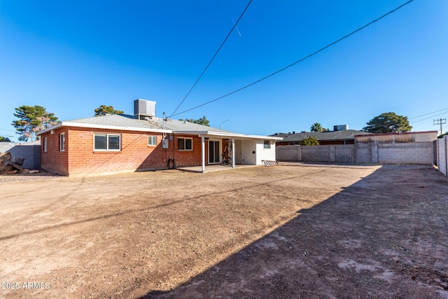 rear view of house featuring central AC and a patio area