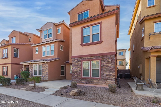 view of front of house featuring central AC unit and a patio area