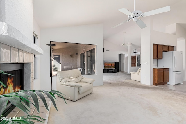 living room featuring ceiling fan, light carpet, and high vaulted ceiling