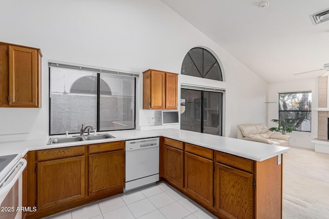 kitchen with white appliances, sink, kitchen peninsula, light tile patterned flooring, and ceiling fan