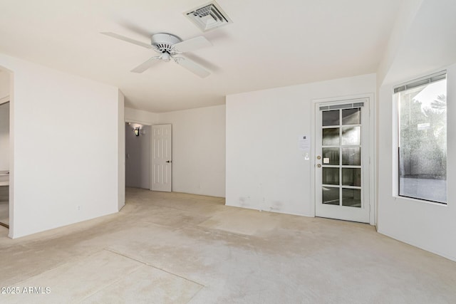 spare room with ceiling fan and light carpet