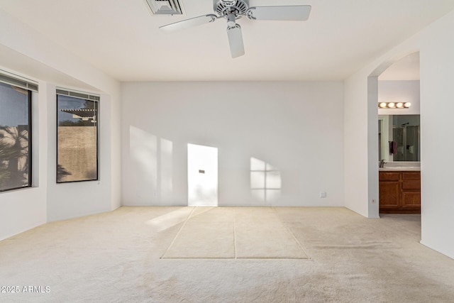 unfurnished room with light carpet, ceiling fan, and sink