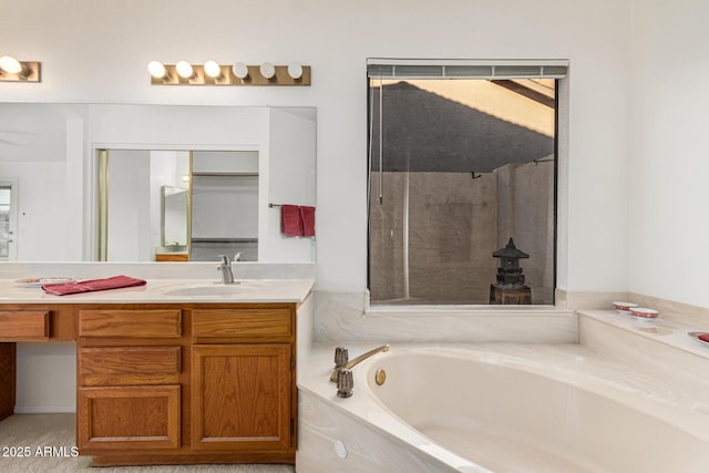 bathroom with a tub to relax in and vanity