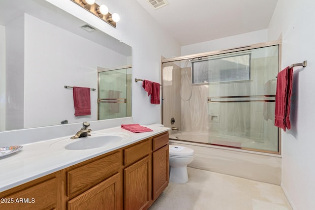 full bathroom featuring bath / shower combo with glass door, toilet, and vanity