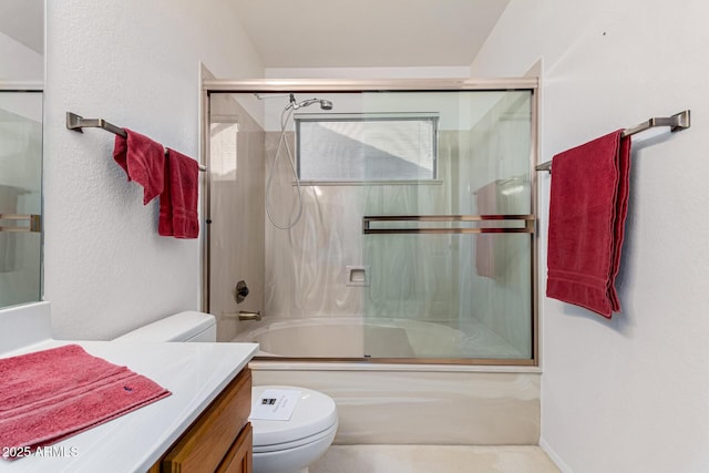 full bathroom with toilet, combined bath / shower with glass door, plenty of natural light, and vanity