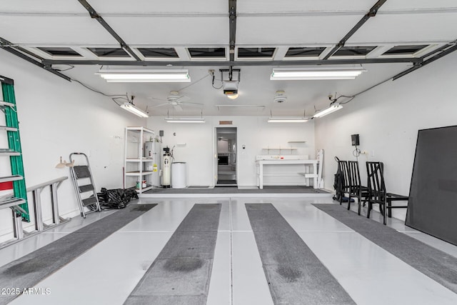 garage with water heater and a garage door opener