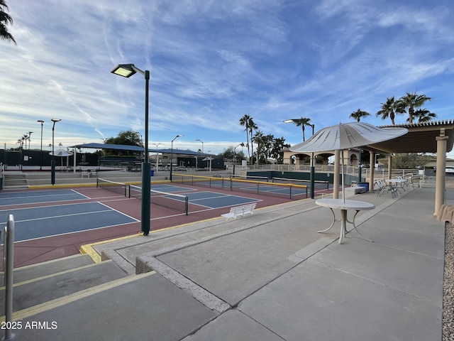 view of property's community featuring tennis court