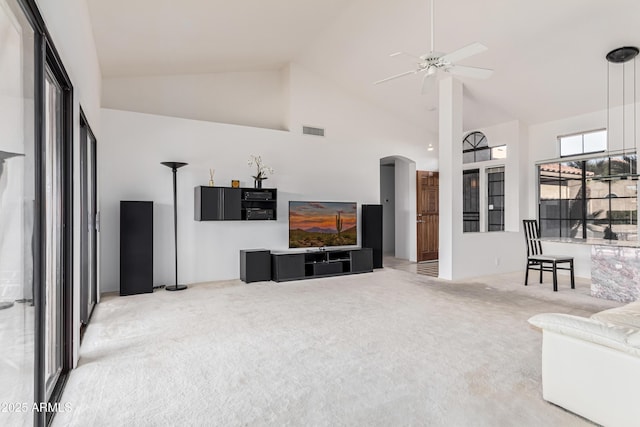 carpeted living room featuring ceiling fan and high vaulted ceiling