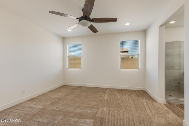 carpeted spare room featuring plenty of natural light, recessed lighting, baseboards, and ceiling fan