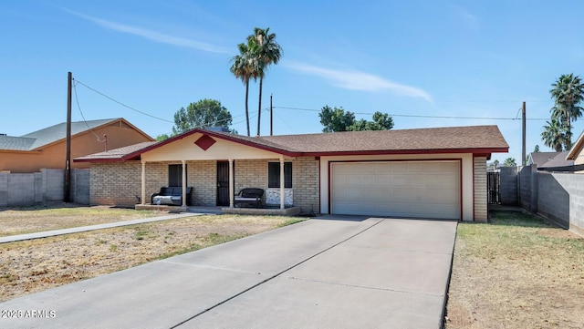 ranch-style house featuring fence, an attached garage, brick siding, covered porch, and driveway