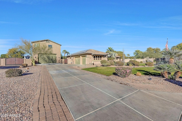 view of front of home featuring a garage and solar panels