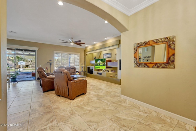 living room featuring ceiling fan and ornamental molding