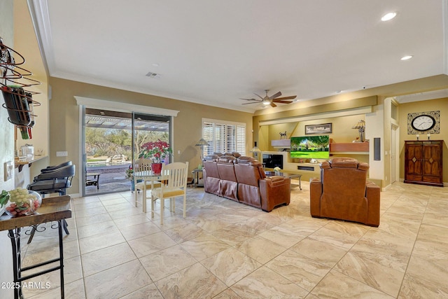 living room featuring ceiling fan and ornamental molding