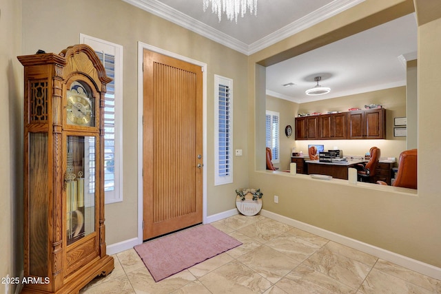 foyer featuring ornamental molding and built in desk