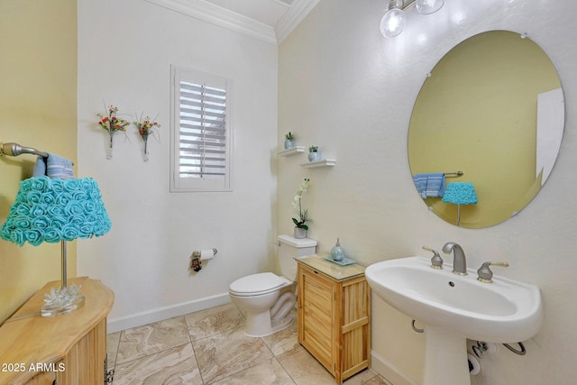 bathroom with sink, toilet, and ornamental molding