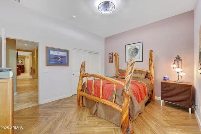 bedroom featuring light parquet floors and a closet