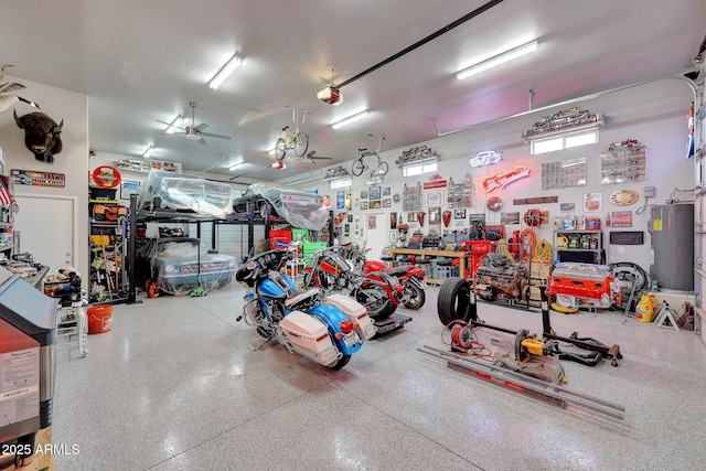 garage with ceiling fan, water heater, and a workshop area