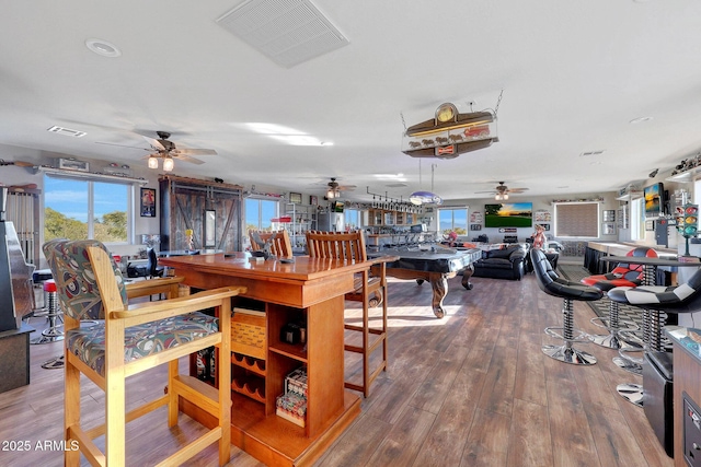 dining space with ceiling fan, plenty of natural light, and wood-type flooring