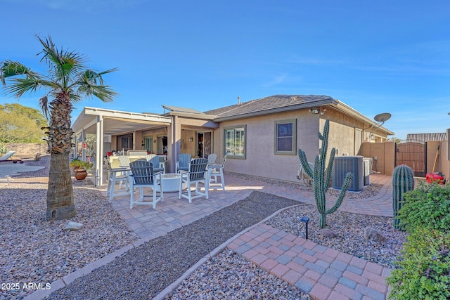 rear view of house with a patio area and central AC unit