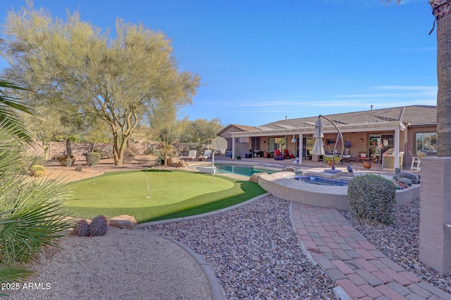 view of yard with a pool with hot tub and a patio area