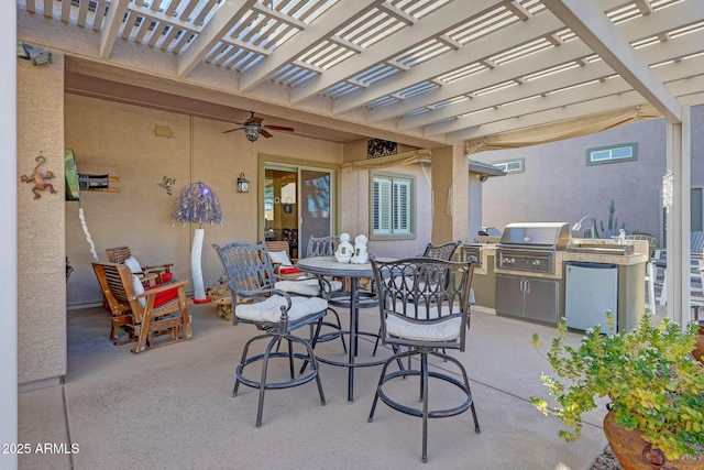 view of patio with grilling area, a pergola, and exterior kitchen