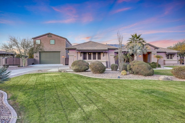 view of front facade featuring a lawn and a garage