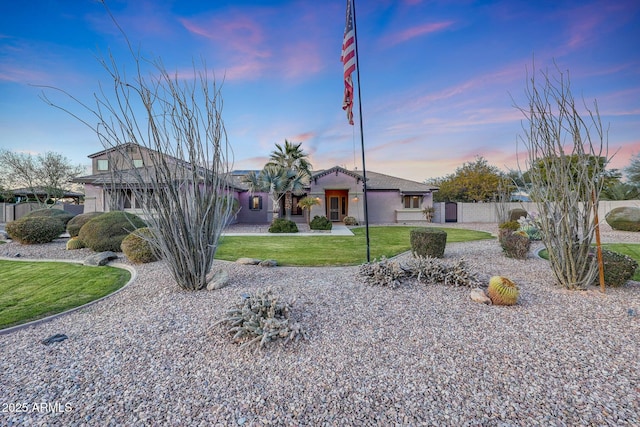 ranch-style home featuring a yard