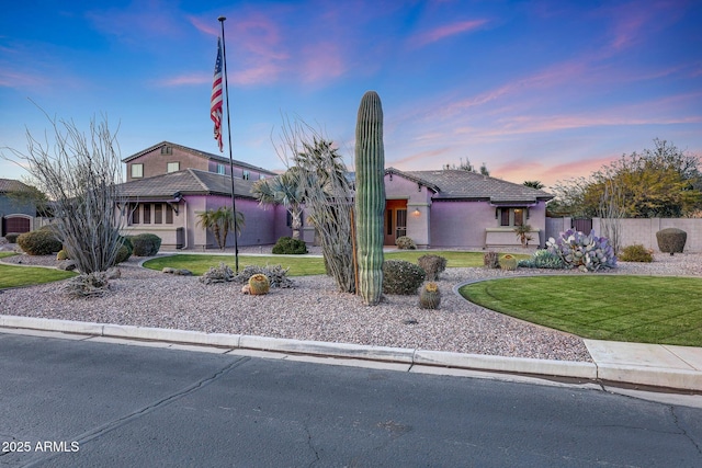 view of front of property with a lawn