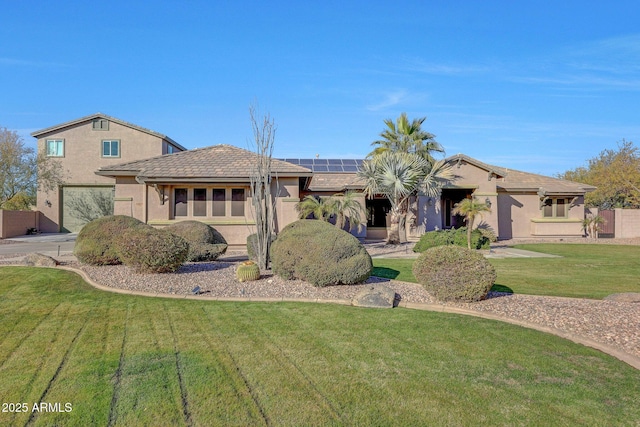 single story home with solar panels and a front lawn