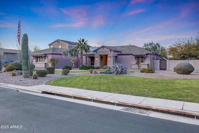 mediterranean / spanish-style home with a lawn