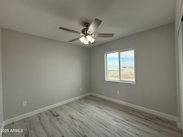 unfurnished room featuring ceiling fan and light wood-type flooring