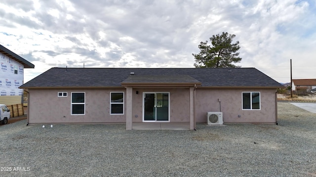 rear view of house featuring ac unit and a patio