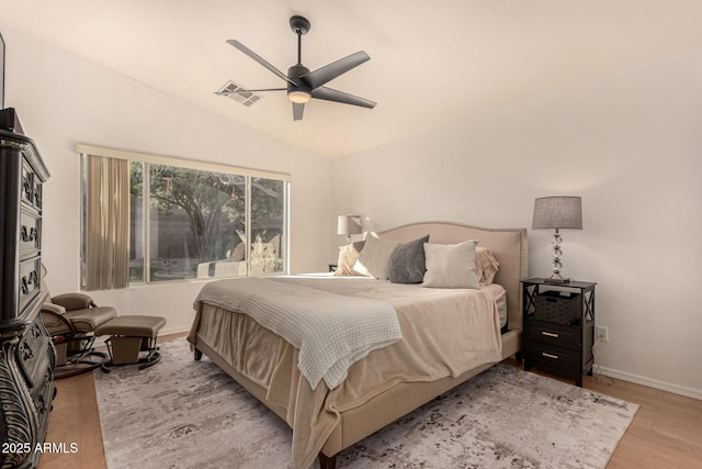 bedroom featuring lofted ceiling, light wood-type flooring, and ceiling fan