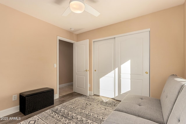 bedroom featuring wood-type flooring, ceiling fan, and a closet