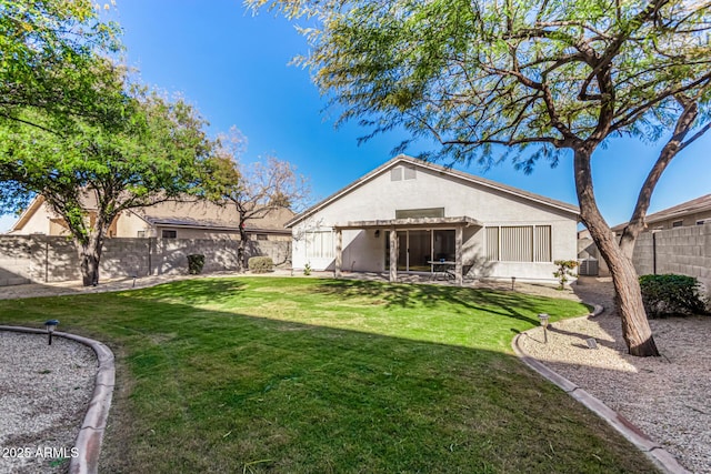 rear view of property featuring a yard