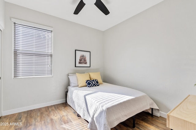 bedroom with wood finished floors, baseboards, and ceiling fan