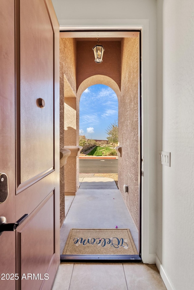 doorway to property with stucco siding and a balcony