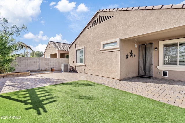 view of yard with central air condition unit, a patio, and fence